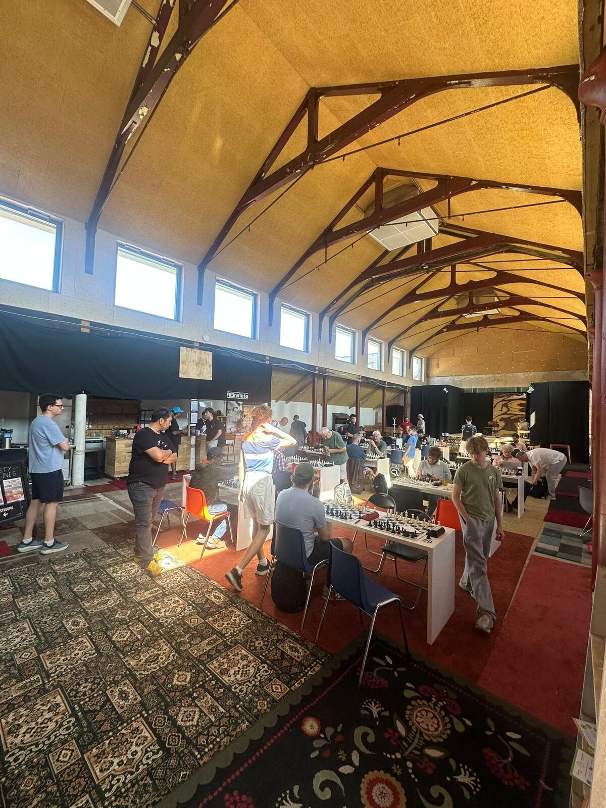 The Great Hall in use: chess tables and visitors beneath the restored timber roof